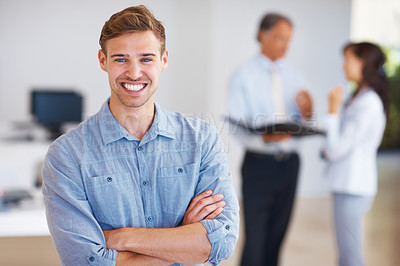 Buy stock photo Portrait of handsome young business man standing with arms crossed in office