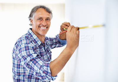 Buy stock photo Portrait of smiling mature engineer measuring walk with masking tape