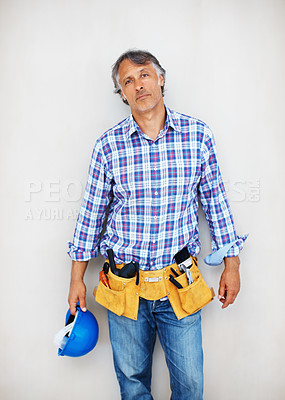 Buy stock photo Portrait of mature construction worker holding protective helmet