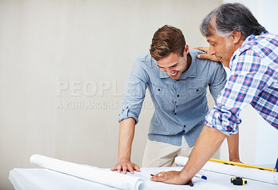 Buy stock photo Young man discussing home renovation plan with architect