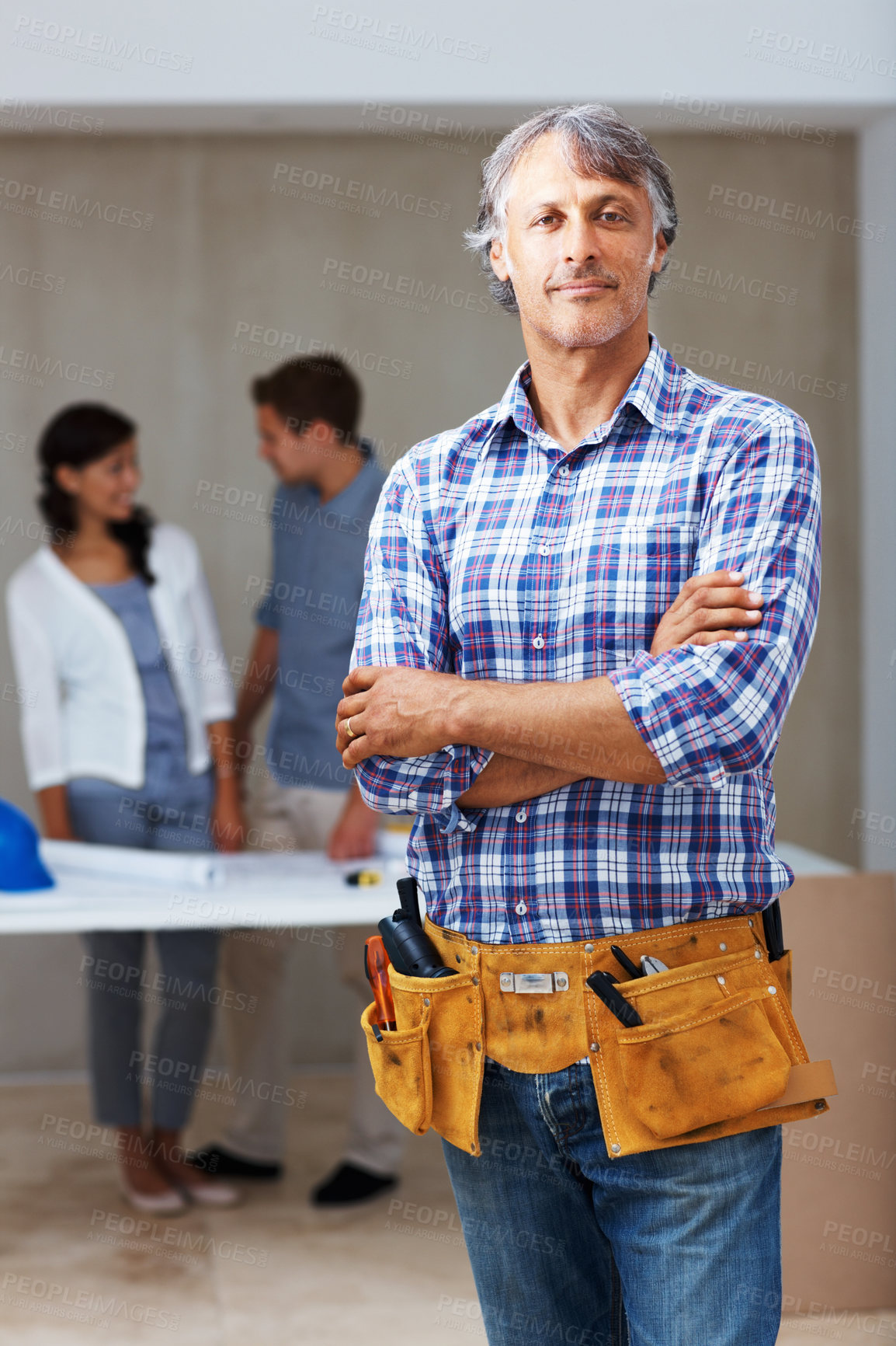 Buy stock photo Portrait of confident male contractor standing with clients discussing in background