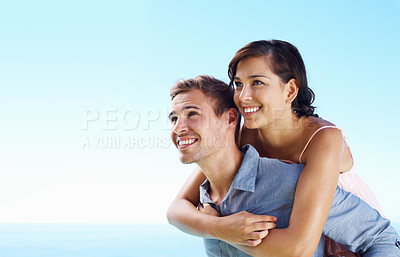 Buy stock photo Ocean, couple and smile with piggyback for bonding with love, trust and support in Spain. People, relationship and smile for care on holiday or vacation for honeymoon, relax and break in outdoor