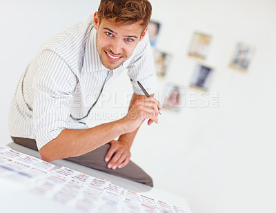 Buy stock photo Portrait of smart smiling photographer sitting on table and viewing images