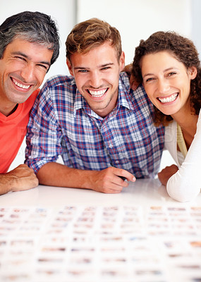 Buy stock photo Portrait of professional photographers sitting together and smiling