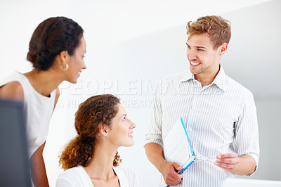 Buy stock photo Business man with file and glasses discussing with two female colleagues