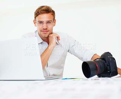 Buy stock photo Smile, man and photographer with portrait in office, camera and laptop with catalog for research trend topics. Male visual artist, creative agency and online for project management and editing photos