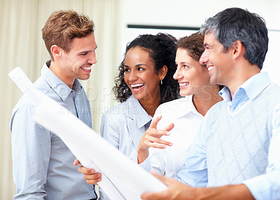 Buy stock photo Team of successful engineers in discussion with blueprint