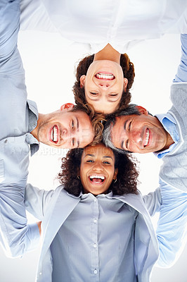 Buy stock photo Low angle view of business group in a huddle smiling and looking at you