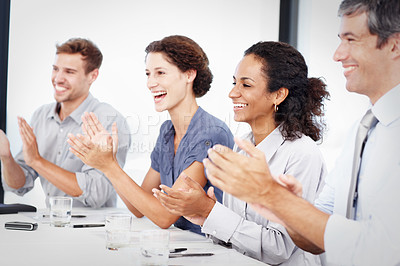 Buy stock photo Profile shot of a group of young business people clapping hands at a meeting