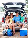 Cute family sitting in the back of a car