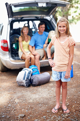 Buy stock photo Portrait, child and girl with smile, camping and outdoor for adventure in forest, family and bonding. Nature, daughter and parents in woods with car, road trip and happy at campsite in Australia