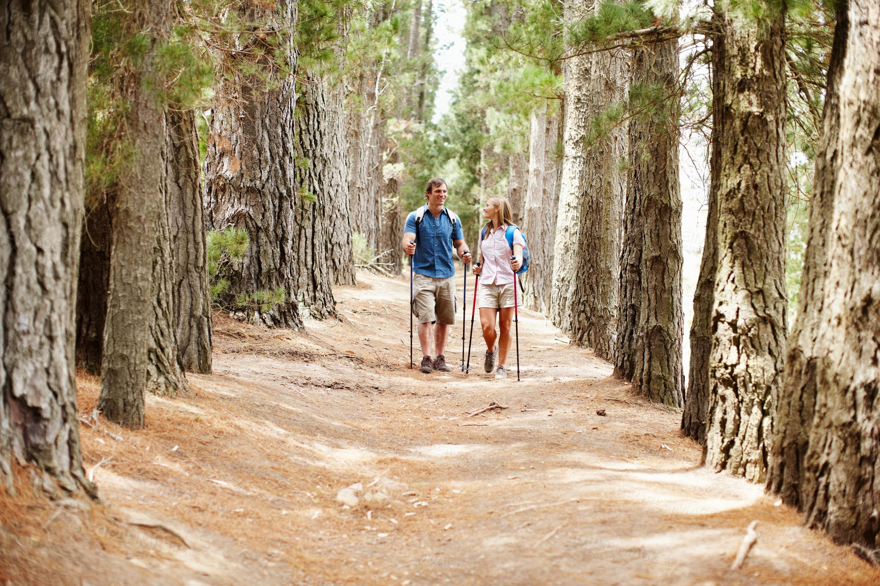 Buy stock photo Happy people, hiking and gear with countryside, walk and nature for travel, adventure and bonding. Couple, journey and backpack for discovery, fitness and exploring for recreation, outdoor and sports