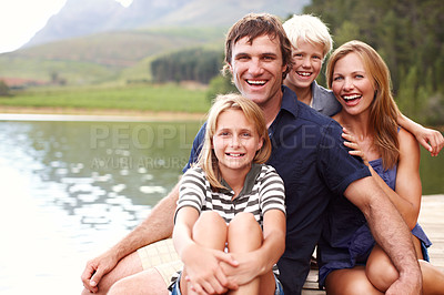 Buy stock photo Portrait, family and fun in nature, lake and holiday for parents and children, vacation and outdoor. Water, mom and dad with kids, bonding and travel to river for peace, man and woman with smile