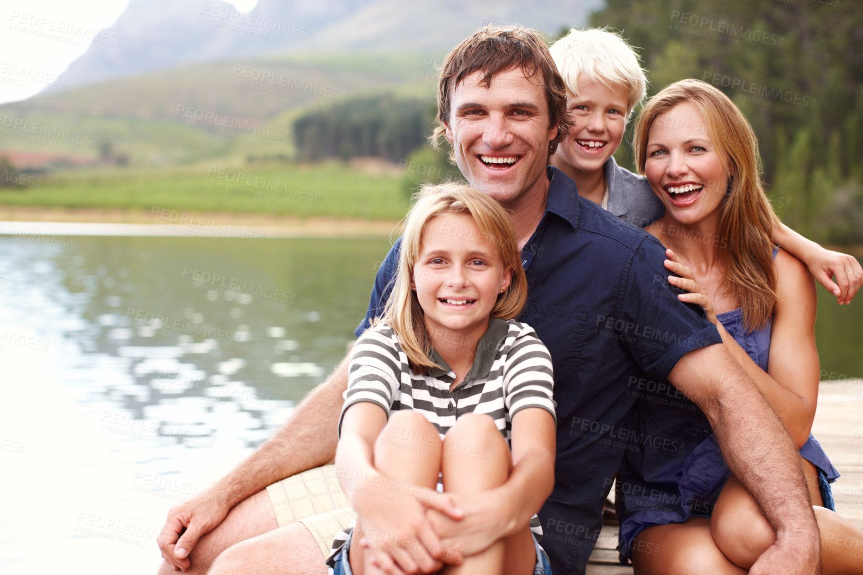 Buy stock photo Portrait, family and fun in nature, lake and holiday for parents and children, vacation and outdoor. Water, mom and dad with kids, bonding and travel to river for peace, man and woman with smile