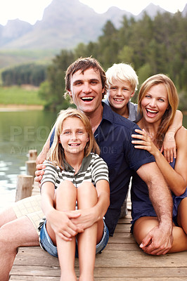 Buy stock photo Portrait, family and smile in nature, lake and holiday for parents and children, vacation and fun. Water, mom and dad with kids, bonding and travel to river, man and woman with peace and laughing