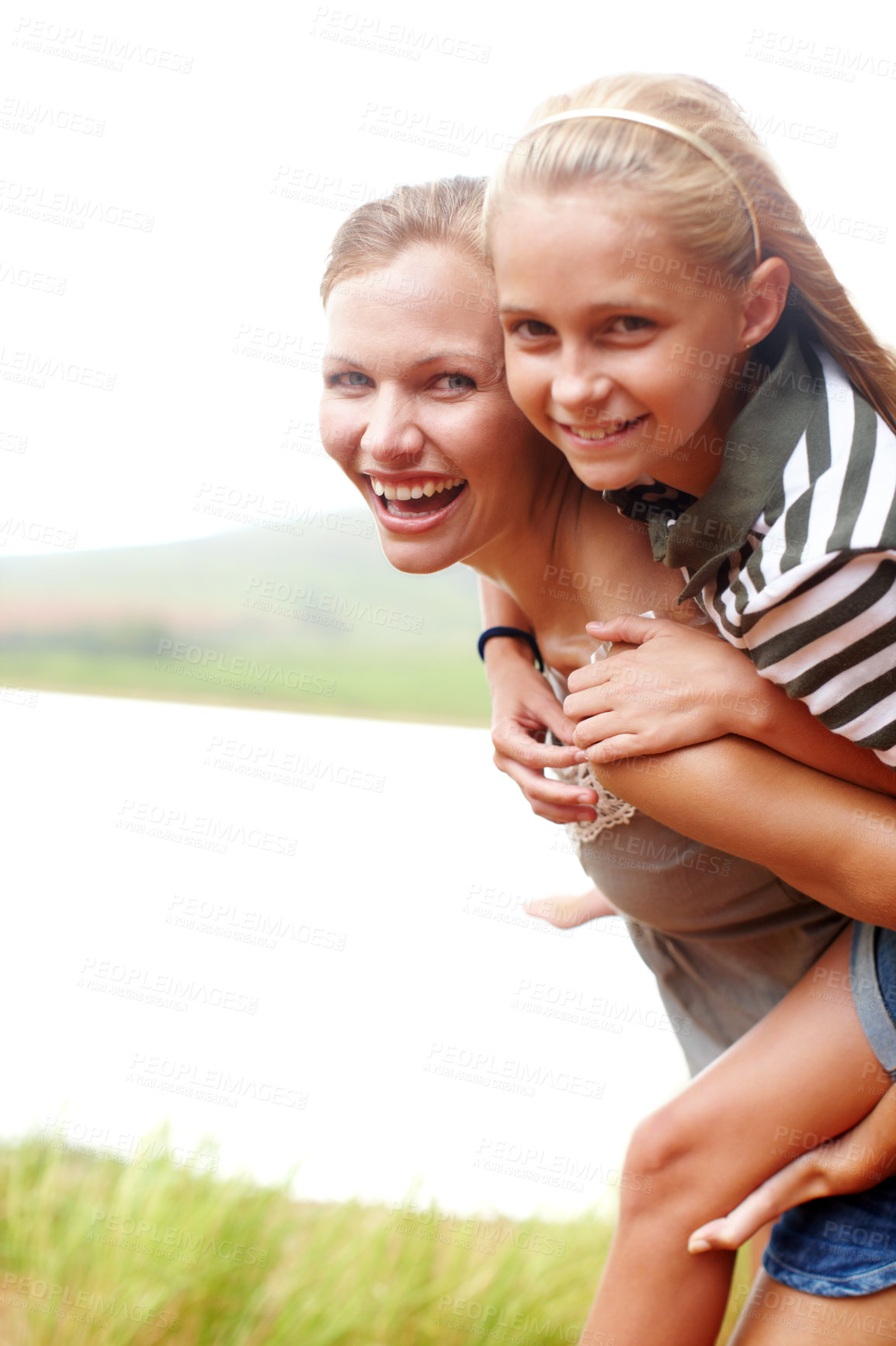 Buy stock photo Mom, happy girl and piggyback portrait in nature, connection and laugh for adventure in countryside. Mother, daughter and carrying support or games by river, love and bonding on holiday in outdoor