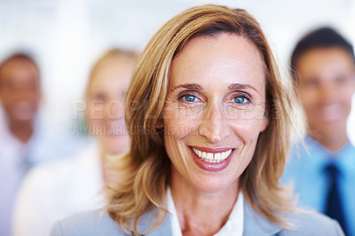 Buy stock photo Closeup of mature female executive smiling with team in seminar