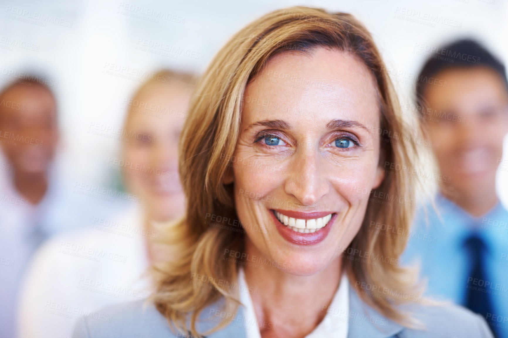 Buy stock photo Closeup of mature female executive smiling with team in seminar