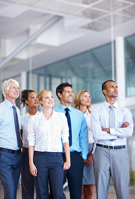 Buy stock photo Portrait of multi racial business partners looking away together at office