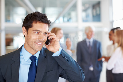 Buy stock photo Portrait of smart male executive on call with business team discussing in background