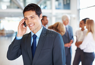 Buy stock photo Portrait of attractive male executive on call with business people discussing in background