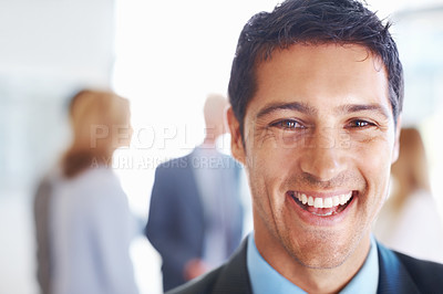 Buy stock photo Closeup of cheerful business man smiling with executives discussing in background