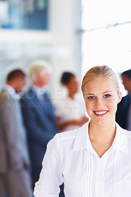 Buy stock photo Portrait of confident female executive with business group in background