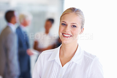 Buy stock photo Portrait of smiling young business woman with executives in background