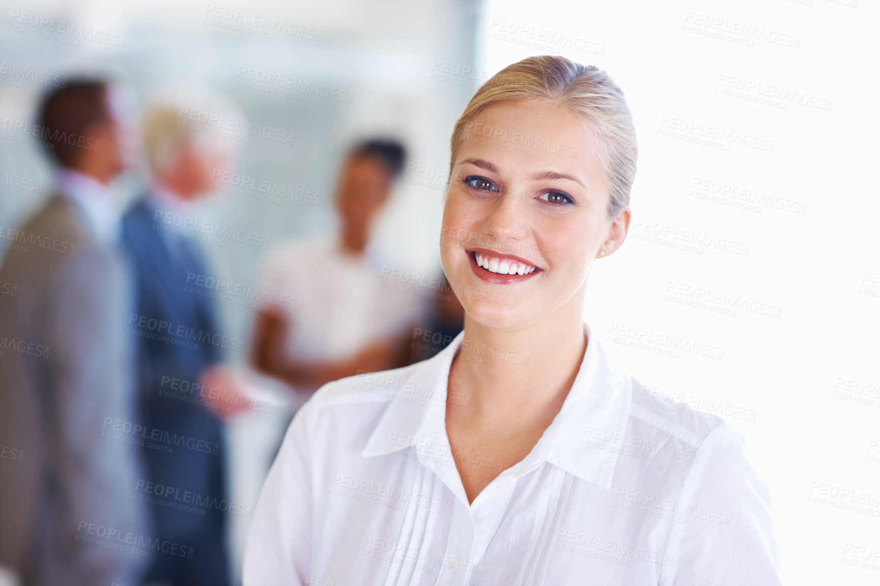 Buy stock photo Portrait of smiling young business woman with executives in background