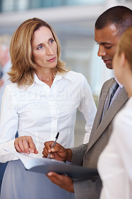 Buy stock photo Diverse group of business people discussing about documents