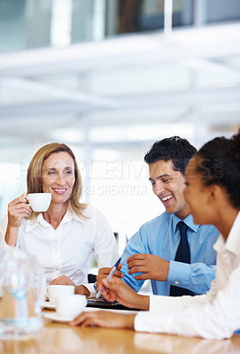 Buy stock photo Portrait of mature female leader smiling with her employees at conference room