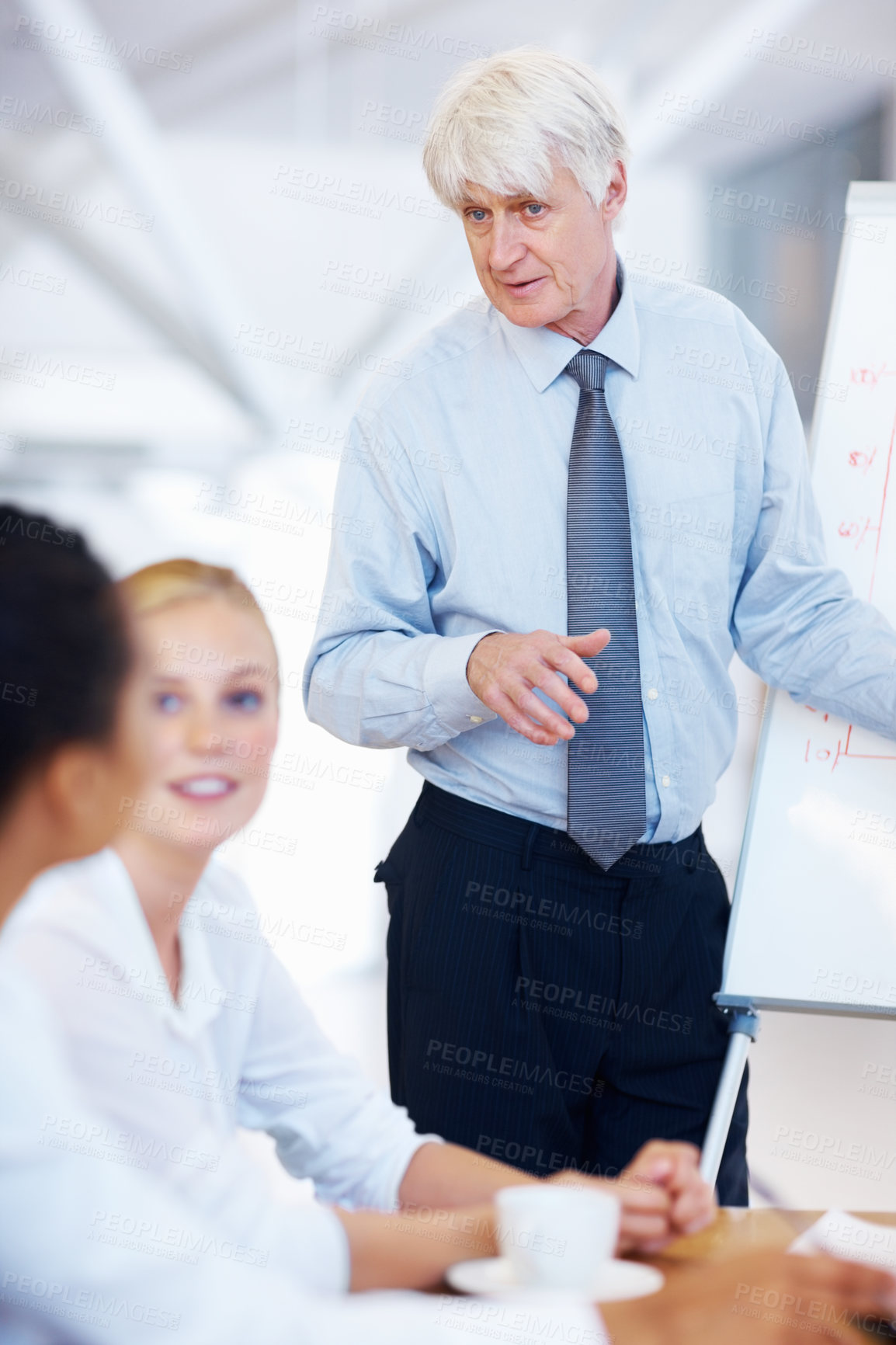 Buy stock photo Mature businessman, coach and meeting with whiteboard for presentation, brainstorming or company mission. Man, executive or mentor with team or group of employees for collaboration at workplace