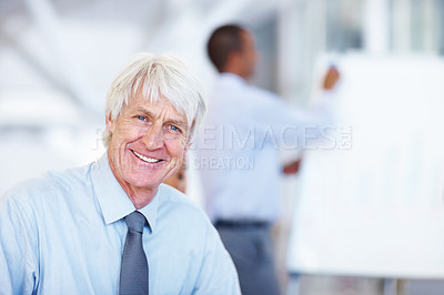 Buy stock photo Portrait of senior business man smiling with male executive in background