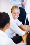 Smiling business woman with executives in seminar room