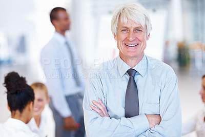 Buy stock photo Portrait of confident senior male executive smiling with business people at office