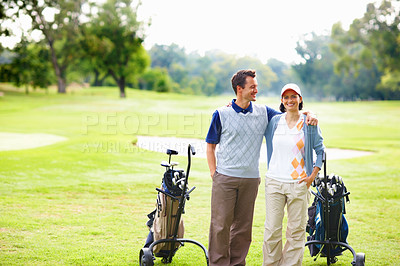 Buy stock photo Portrait of couple standing on golf course with arms around
