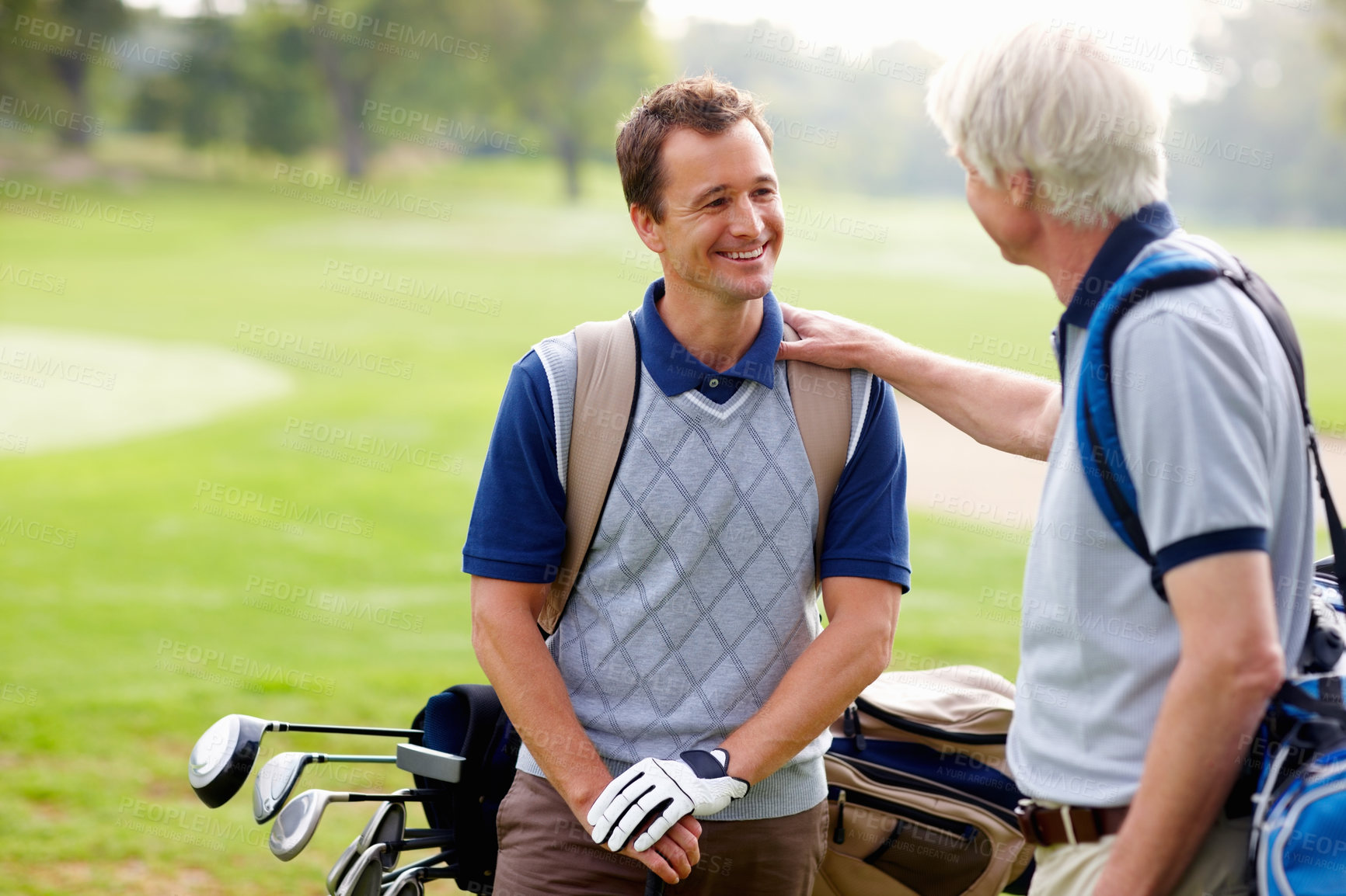 Buy stock photo Father, son and smile on course for golf, sports and bonding outdoor with equipment bag or conversation. Elderly person, man and happy on grass for hobby, good job and playing game at country club