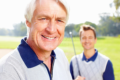 Buy stock photo Closeup of senior man smiling with son holding a golf club in background