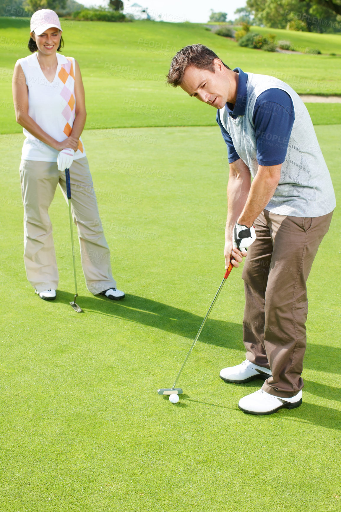 Buy stock photo Game, woman and man on golf course with club for outdoor exercise, fitness and challenge on morning together. Sports, couple and golfer on green grass for competition, support and coaching in nature