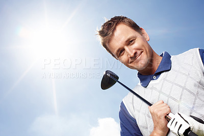 Buy stock photo Smiling mature man holding his golf club while against a blue sky - low angle
