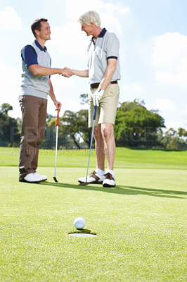 Buy stock photo Two men shaking hands after a satisfying round of golf