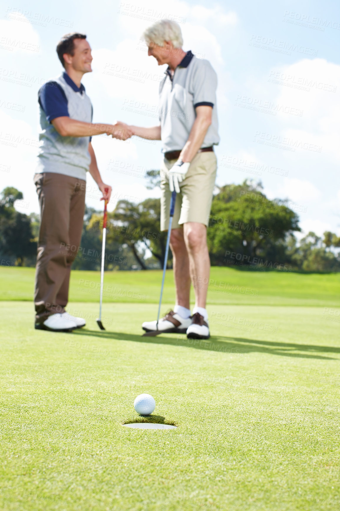 Buy stock photo Game, handshake and men on golf course together for teamwork, outdoor fun and fitness competition at club. Sports, senior father and son shaking hands on green for partnership, bonding and support.