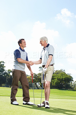 Buy stock photo Smile, handshake and men on golf course together for teamwork, outdoor fun and fitness competition at club. Sports, senior father and son shaking hands on green for partnership, bonding and support.