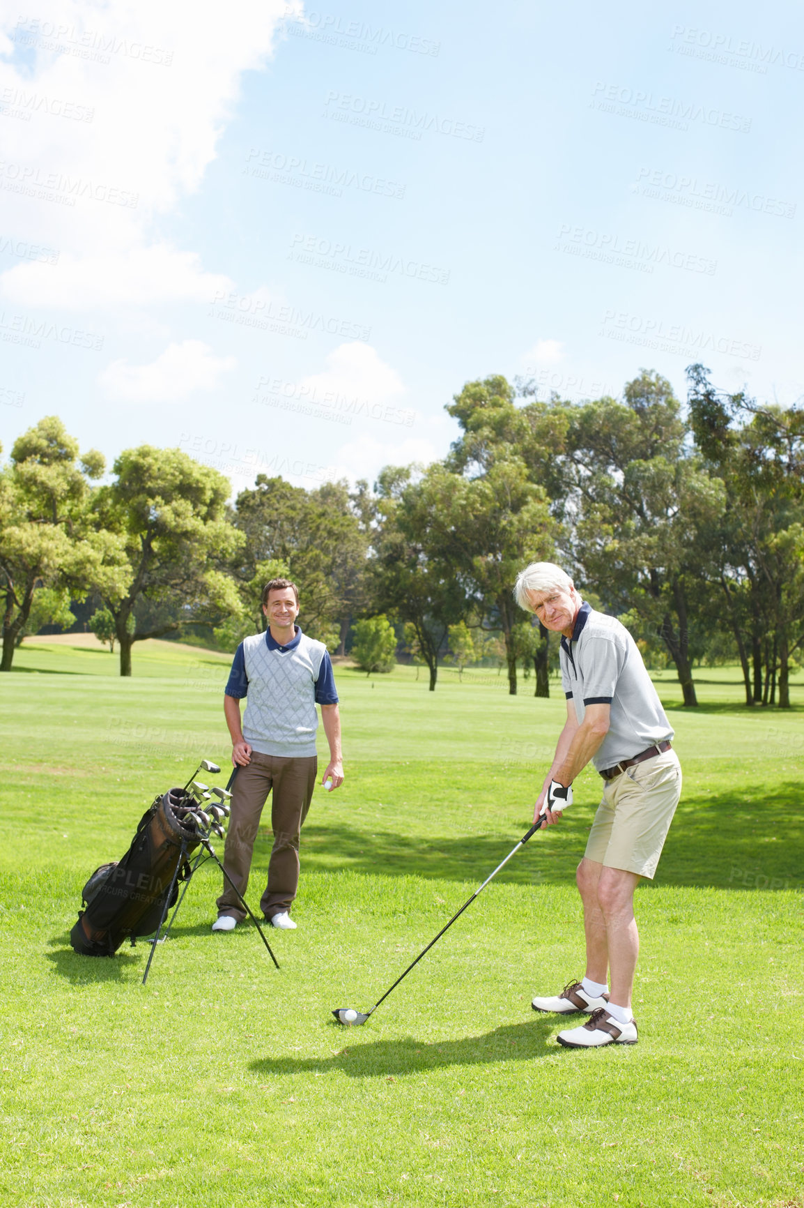 Buy stock photo Golfing companions out on the course playing a round of golf