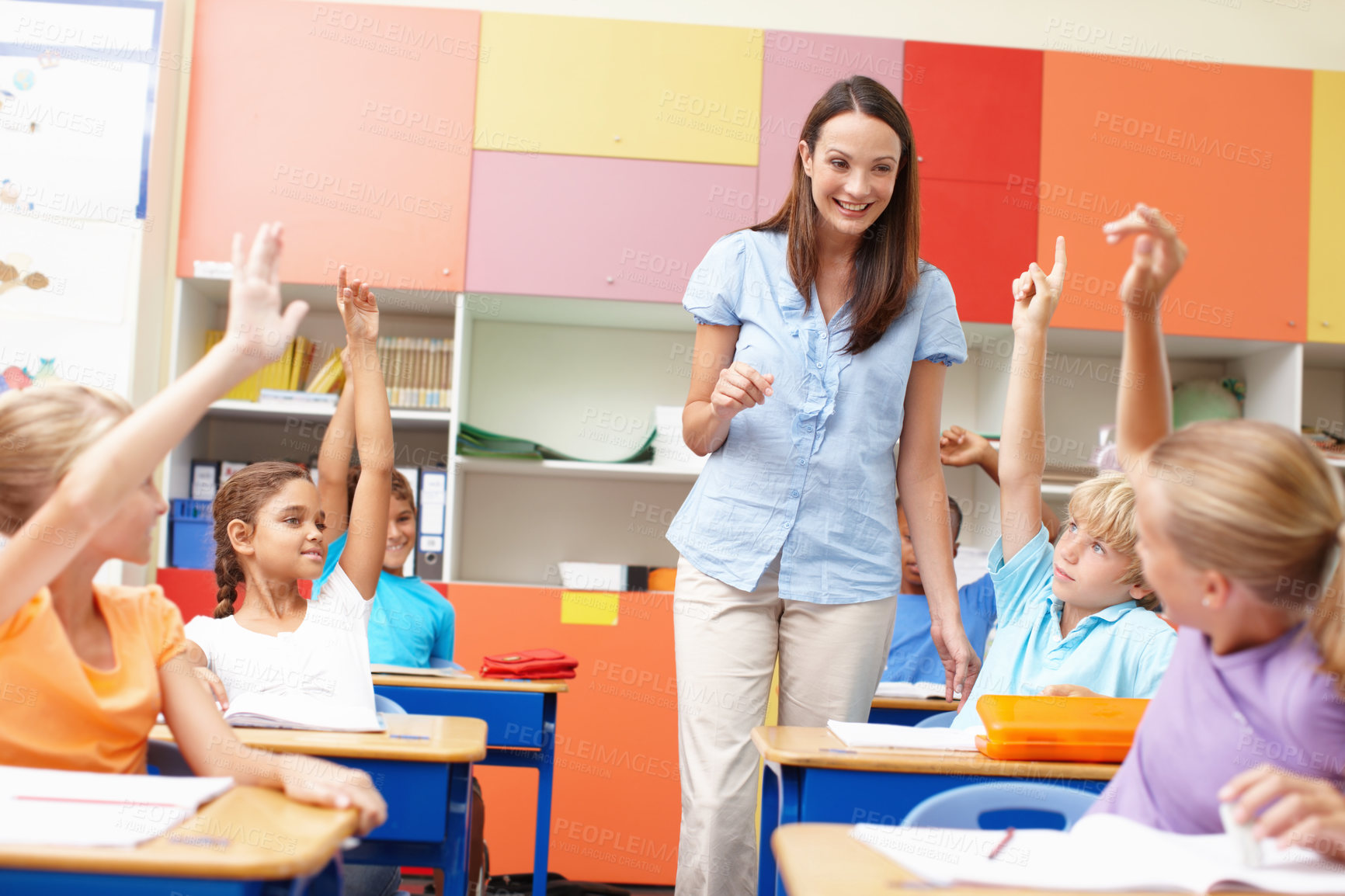 Buy stock photo Learning, children and answer teacher in classroom for question, assessment and education support. Smart students, lesson and hands raised with knowledge, exam quiz and feedback at elementary school