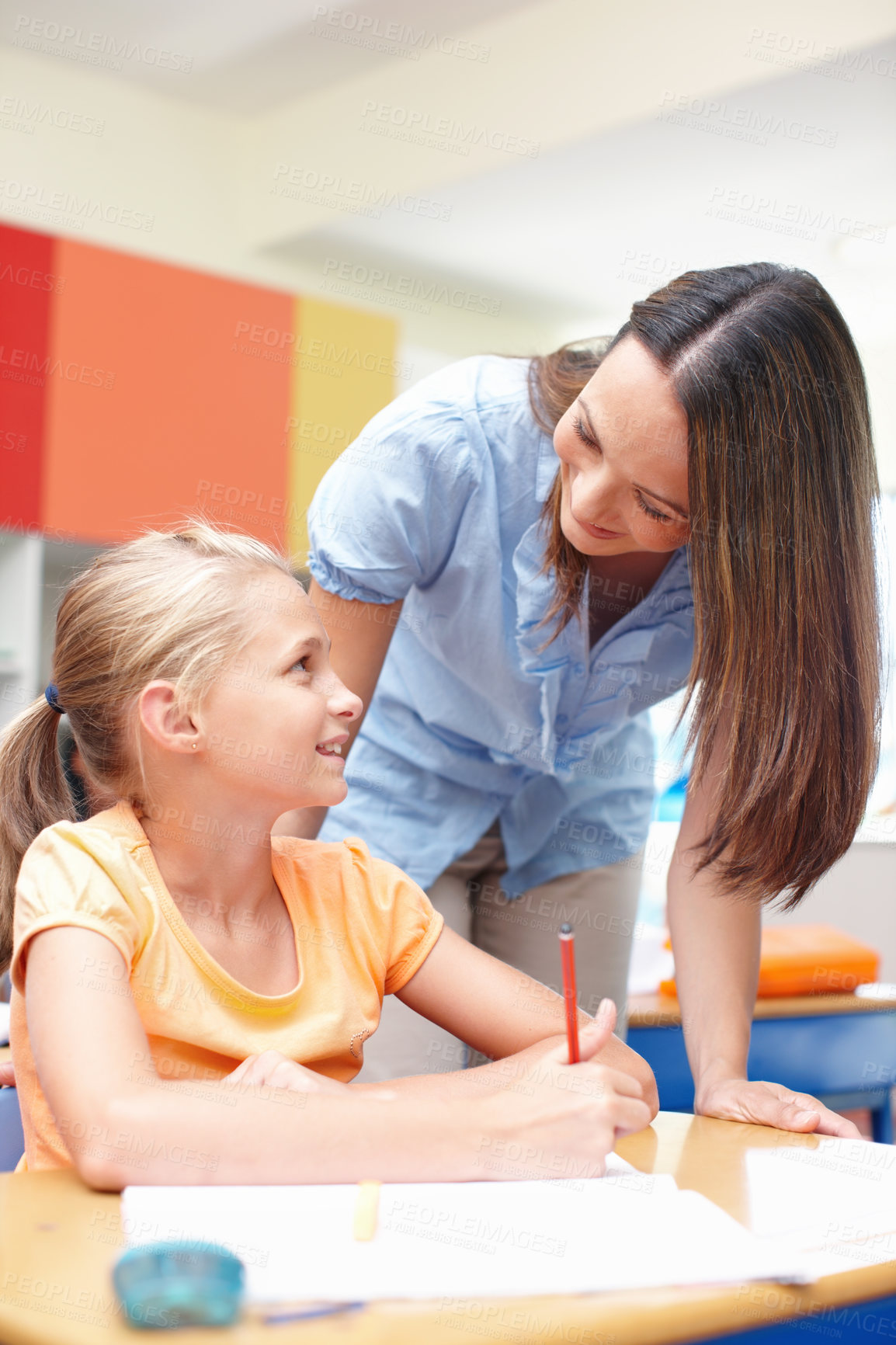 Buy stock photo Classroom, student and woman with help at desk for learning, knowledge and support at school. Academy, teacher and girl with information on paper for education, development and notes for project