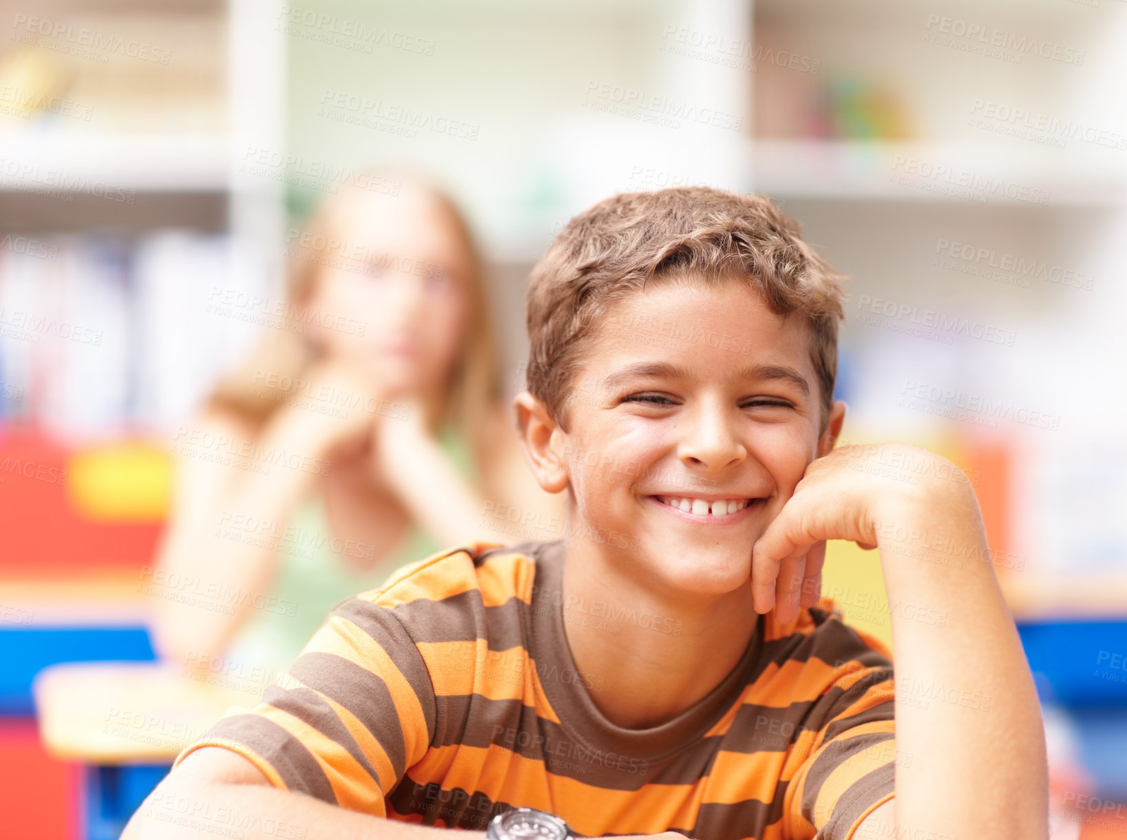 Buy stock photo Smile, portrait and boy in kids classroom for learning, growth and child development at elementary school. Happy, face and student at desk for education, study and future opportunity for scholarship.