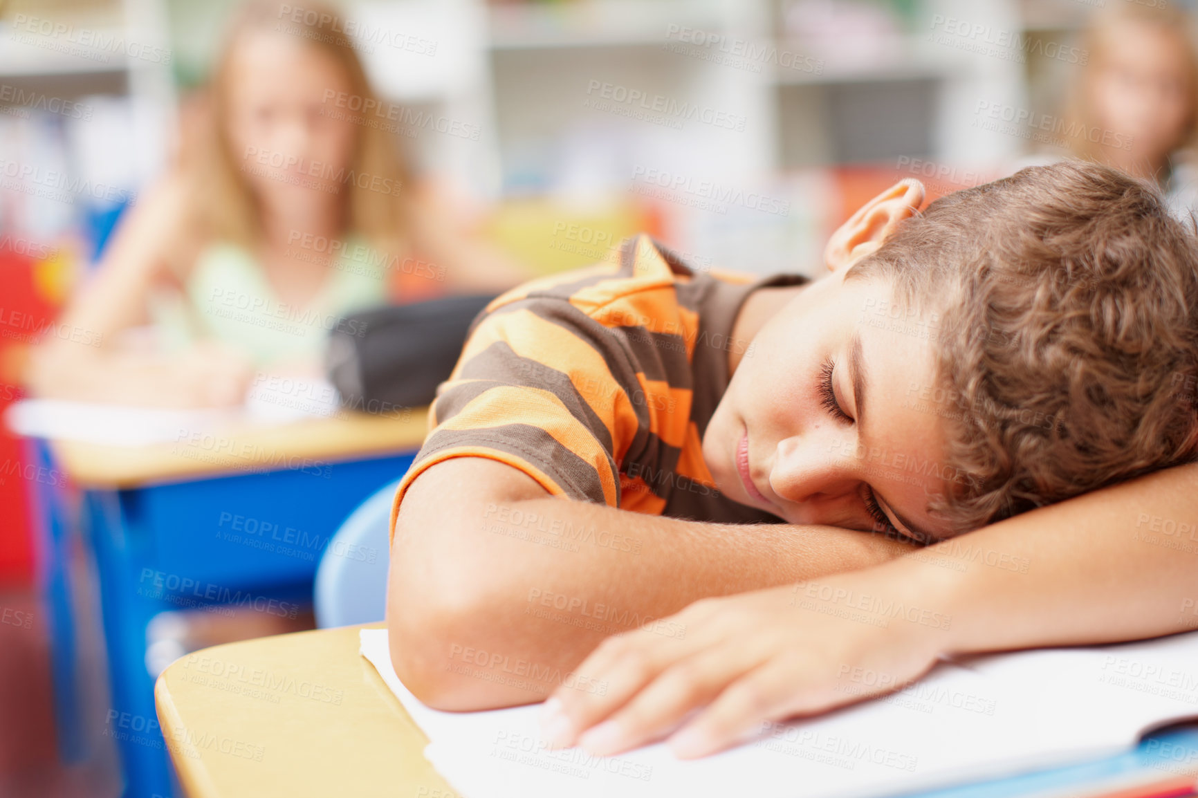 Buy stock photo Boy, student and sleeping in classroom at elementary school with burnout, tired and bored. Learner, kid and exhausted with resting on desk or table for education, learning and brain development 