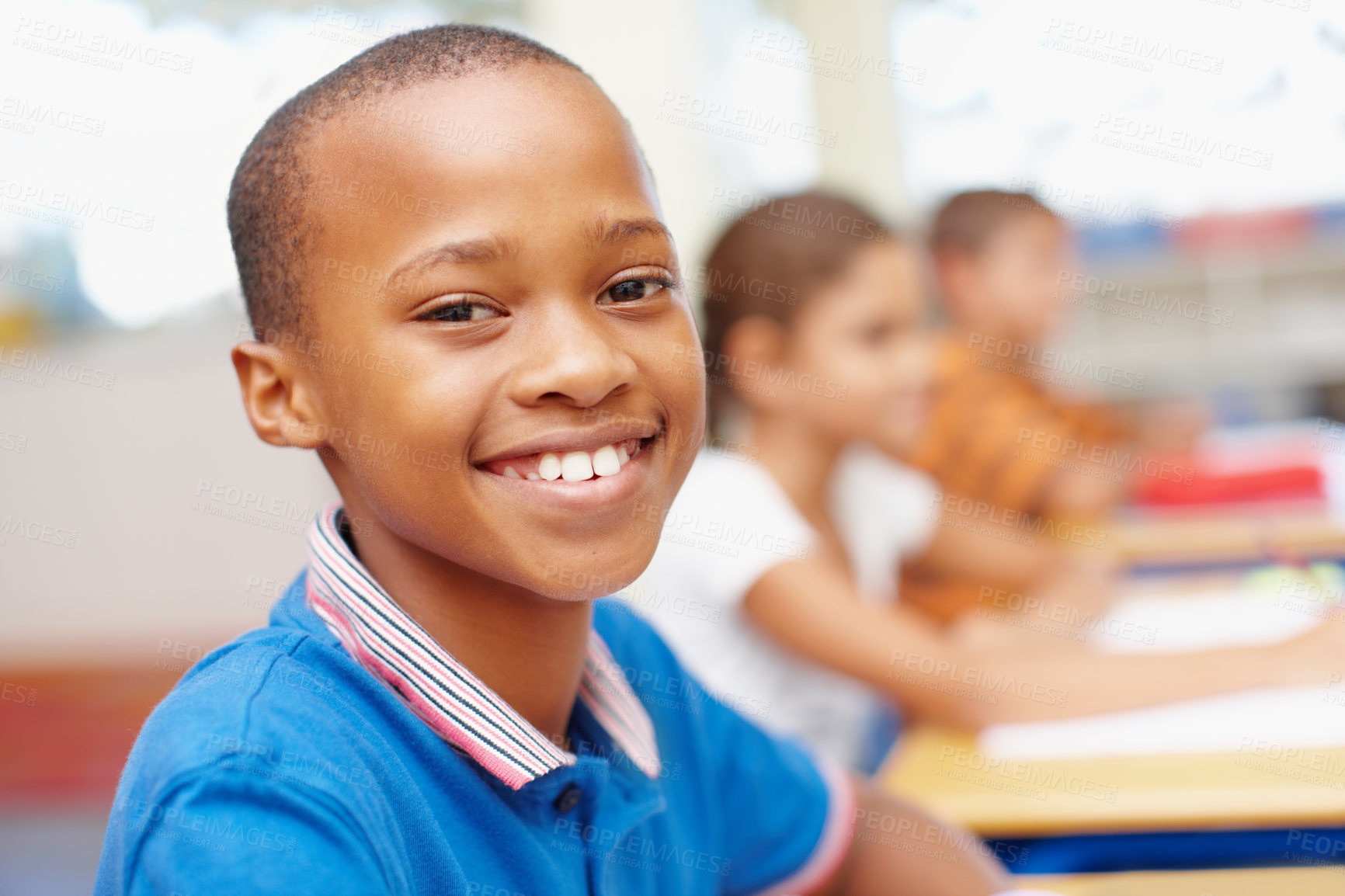 Buy stock photo Smile, portrait and boy in classroom for writing test, growth and child development at elementary school. Happy, face and student at desk for kids education, study and assessment for scholarship.