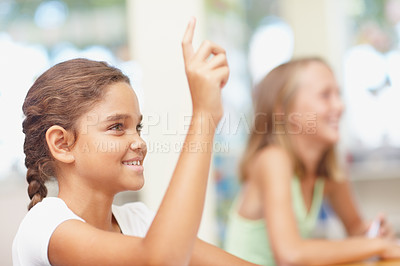 Buy stock photo Learning, girl and answer in classroom for education, assessment question and scholarship with smile. Smart student, lesson and hands raised with knowledge, exam test or feedback at elementary school